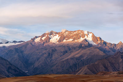 Scenic view of mountains against cloudy sky