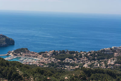 High angle view of sea and cityscape against sky