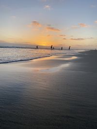 Scenic view of beach against sky during sunset