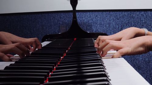 Midsection of person playing piano