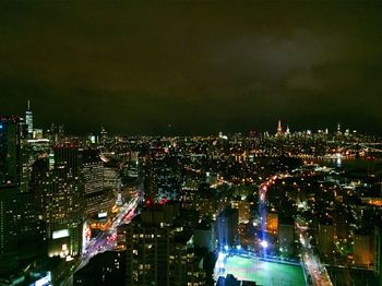 Illuminated cityscape against sky at night