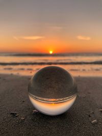 Close-up of sea against sky during sunset