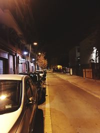 Cars on illuminated street at night