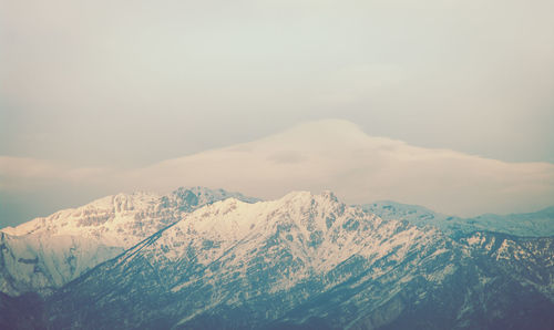 Scenic view of snow covered mountains against sky