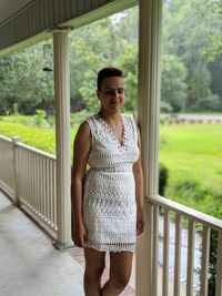 Young woman standing by railing