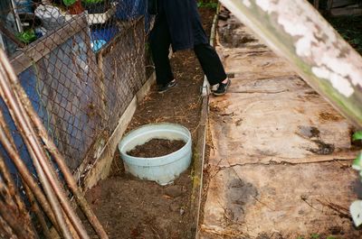 Low section of woman walking in basket