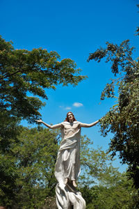 Low angle view of statue against clear blue sky