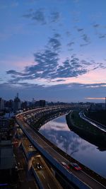 High angle view of bridge over city against sky at sunset