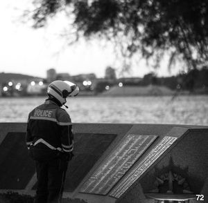 Rear view of man standing by railing