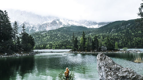 Scenic view of lake and mountains against sky