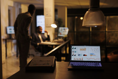 Midsection of businessman working at desk in office