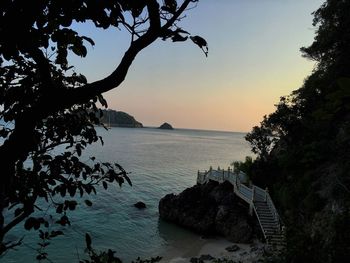 Scenic view of sea against clear sky at sunset