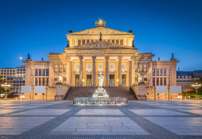 Statue of historic building against blue sky