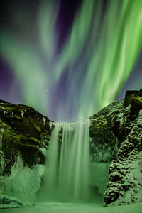 Scenic view of waterfall at night during winter