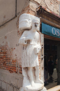 Statue against historic building