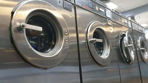 Close-up of washing machine in laundromat