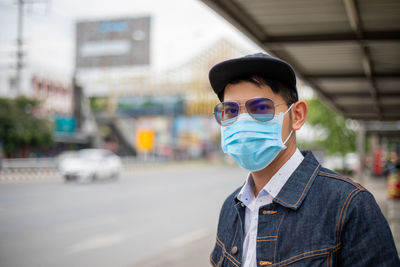 Portrait of man wearing mask standing on street