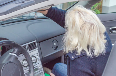 Rear view of woman in car