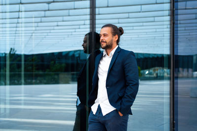 Portrait of young man standing in city