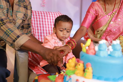 Midsection of boy playing with toys