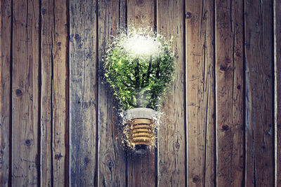 Illuminated light hanging on wall by door