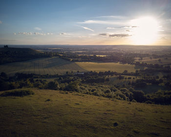 Scenic view of field against sky at sunset