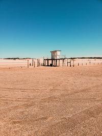 Scenic view of beach against clear blue sky