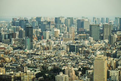 Aerial view of buildings in city against clear sky