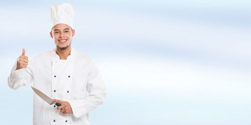 Portrait of a smiling young man standing outdoors