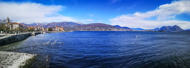 Panoramic view of sea by city against sky