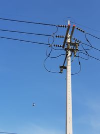 Low angle view of crane against sky