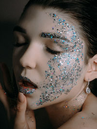 Close-up of woman with glitter on face