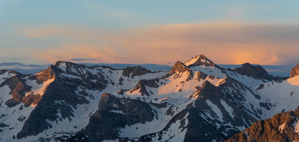 Scenic view of snowcapped mountains against sky during sunset