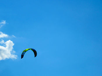 Low angle view of kite flying in blue sky