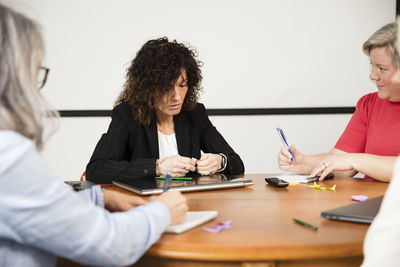 Female friends working at table