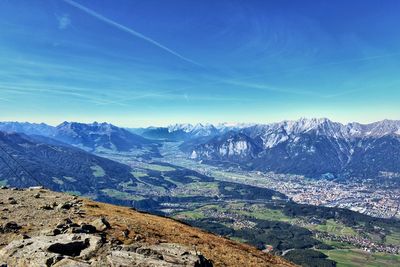 Scenic view of snowcapped mountains against blue sky