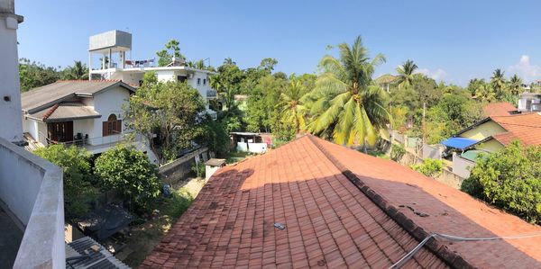 Houses by swimming pool against sky