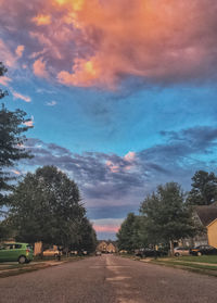 Road amidst trees against sky