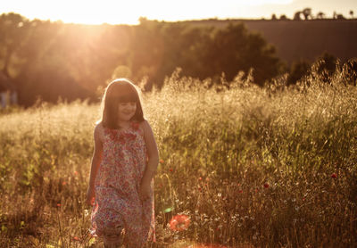 Full length of young girl standing on grassy field