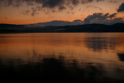 Scenic view of lake against romantic sky at sunset