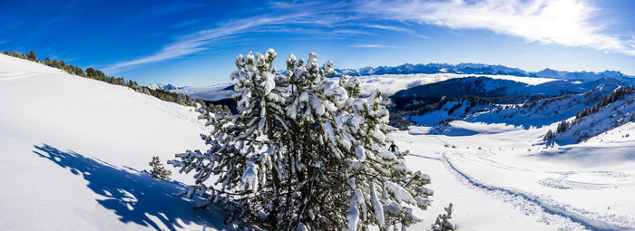Scenic view of snow covered mountains against sky