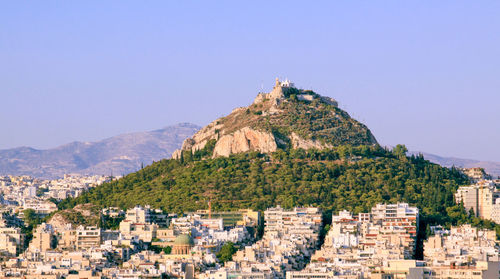 Buildings in city against clear sky