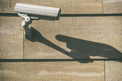 Shadow of security camera on wall