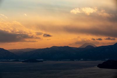 Scenic view of dramatic sky over sea during sunset