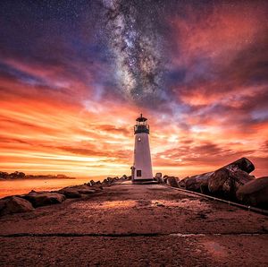 Lighthouse against cloudy sky