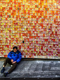 Man sitting on brick wall