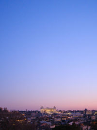 Cityscape against clear sky at dusk