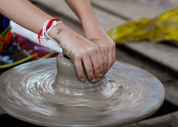 Cropped hand of woman working in workshop