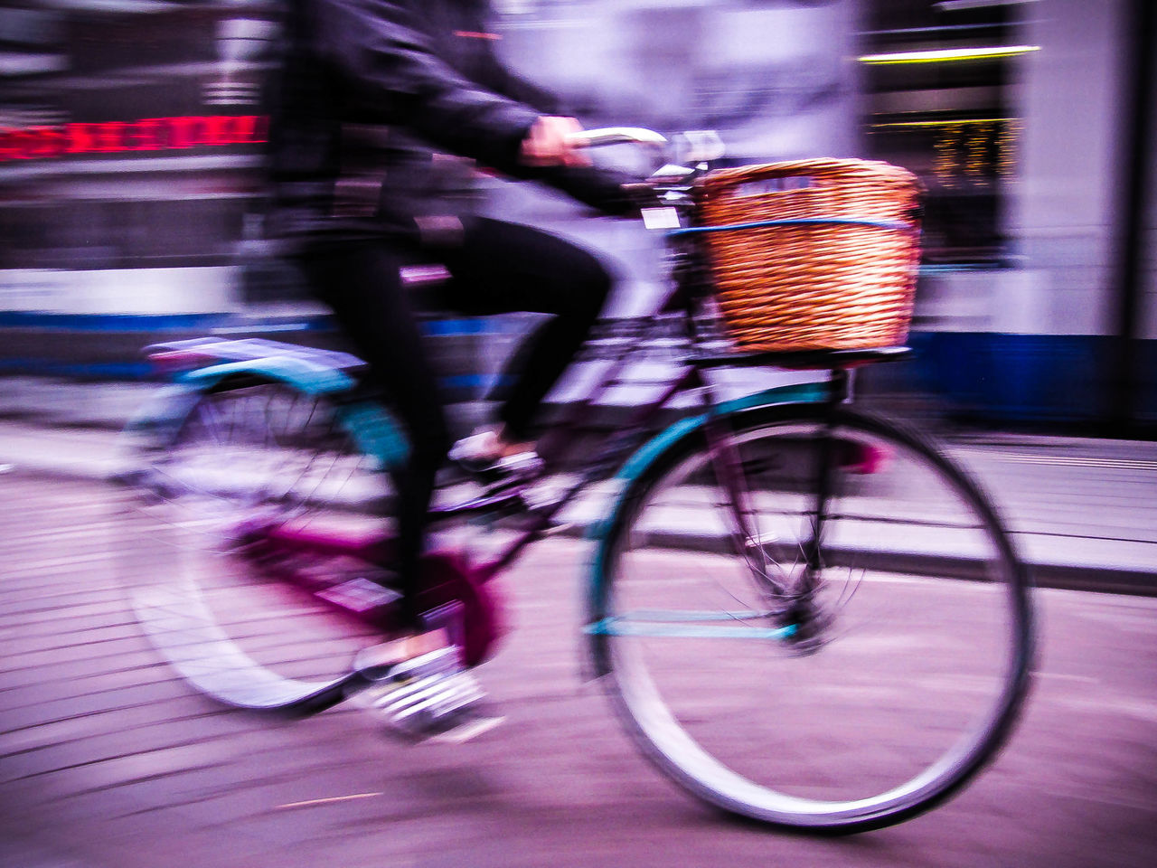 LOW SECTION OF WOMAN RIDING BICYCLE ON STREET