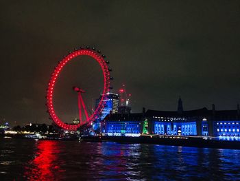 Illuminated ferris wheel at night